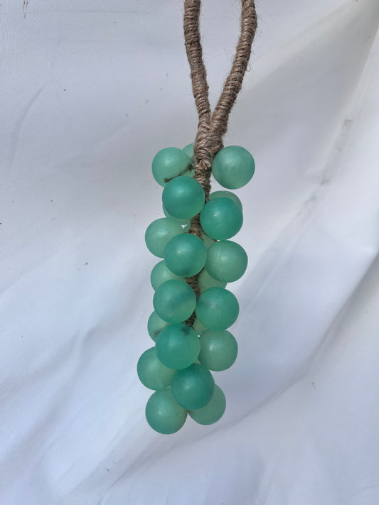 Cluster of seafoam green  soap grapes on a white background